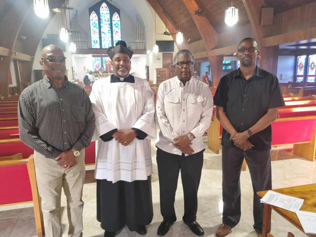 Seen in photo from left Bernard V. Pratt, Assistant Director of Immigration, Officer-in-Charge, Immigration Department, Grand Bahama, Father Kirkland H. Russell, Jr.,Rector, Pro-Cathedral of Christ The King, Freeport, Minister Mitchell, and Montello Gibson, Acting Assistant Director of Immigration, 2nd in Command.