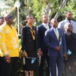 High-Commissioner Leslia Miller-Brice, Parliamentary Secretary Jamahl Strachan watch the flag being raised with MOFA Staffers