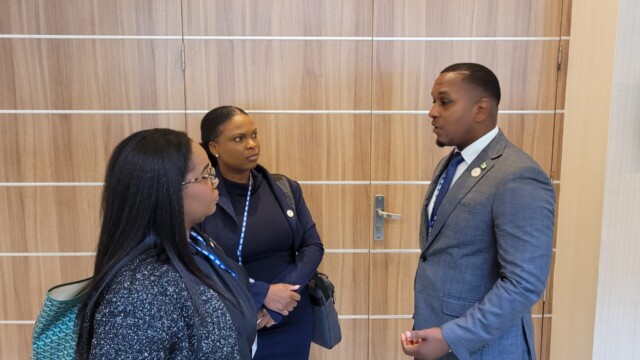 Parliamentary Secretary Strachan (right) preparing for a meeting with FSO Rolanda Davis (foreground) and Alexavia Dean (background)